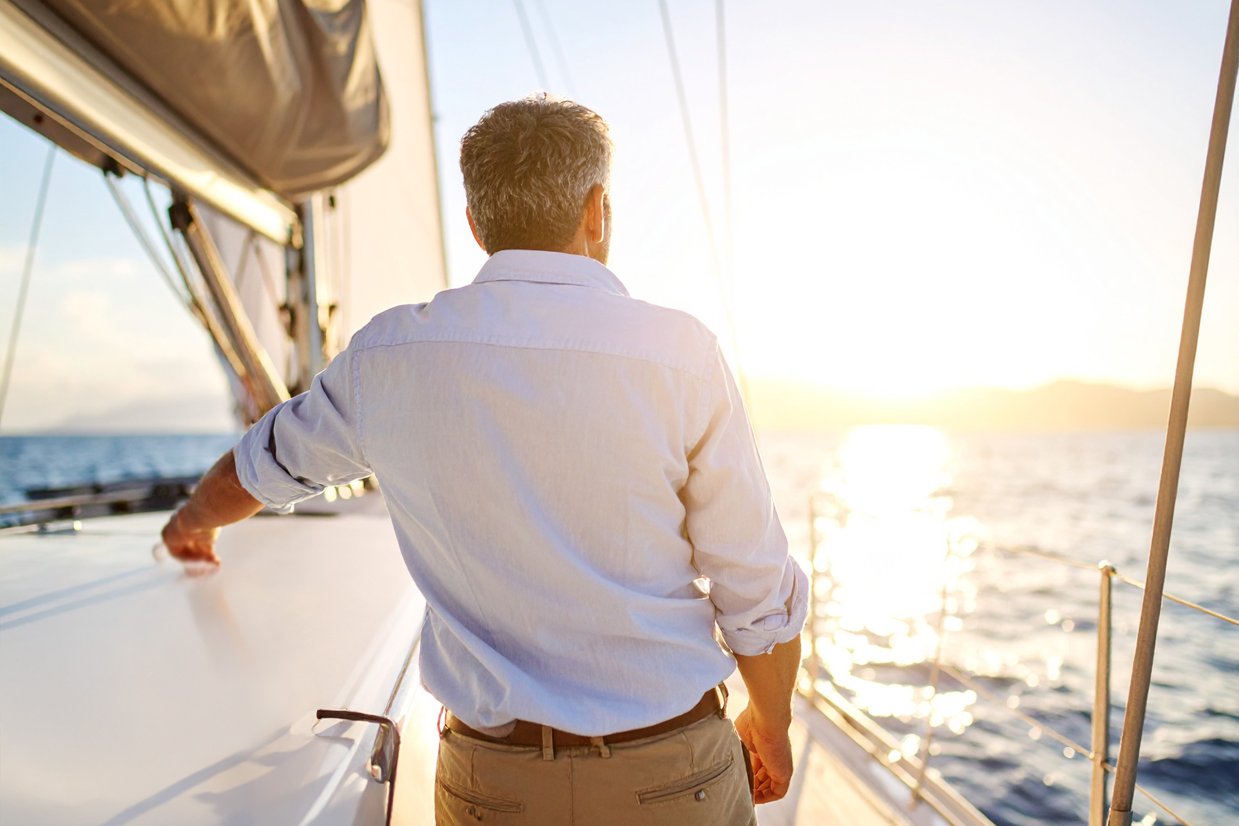 Gentleman looking to the sunset thinking about how Alpine Private Wealth helped him find purpose after retirement.
